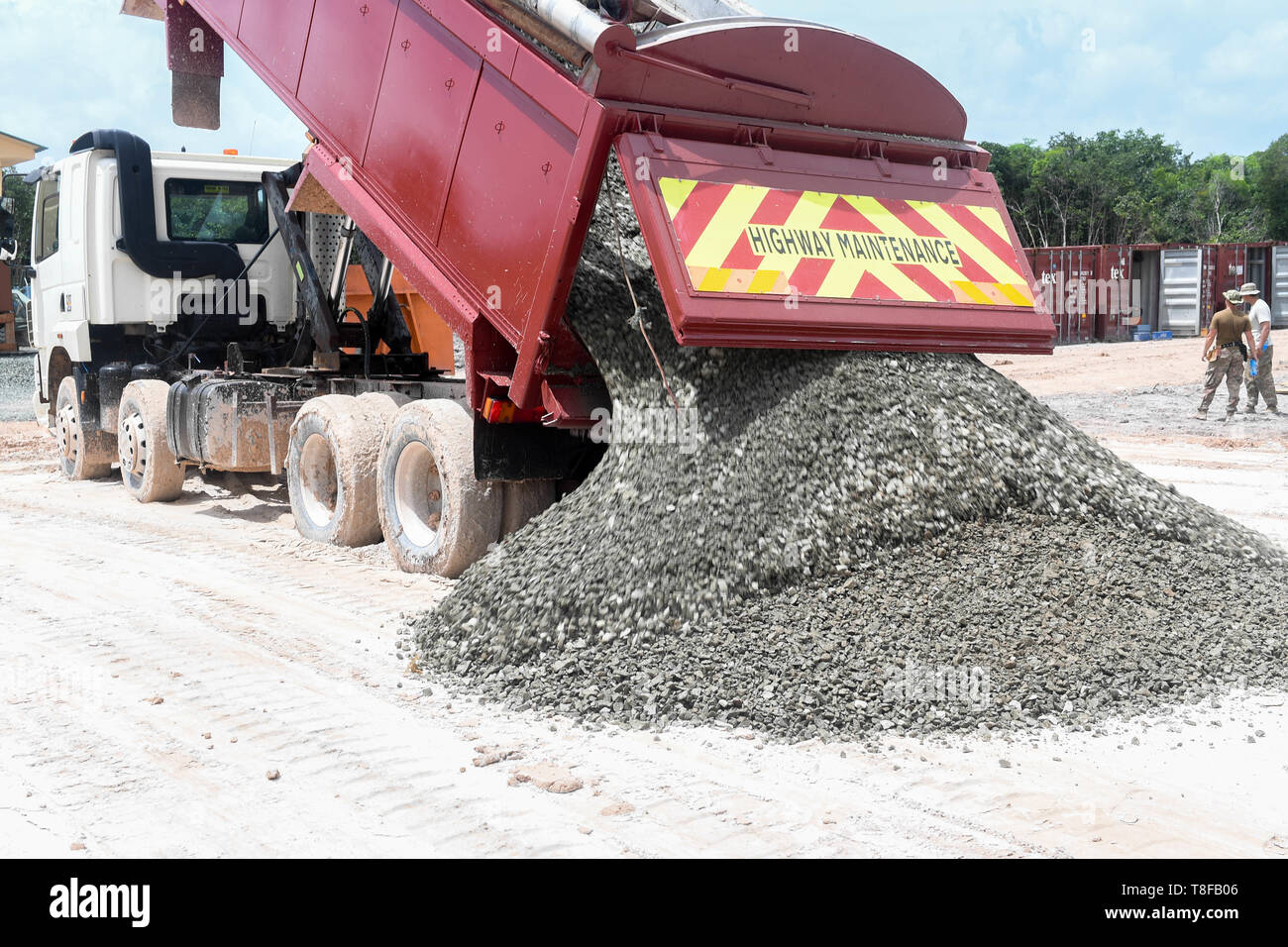 A dump truck unloads gravel during New Horizons exercise 2019 at Camp Seweyo, Guyana, May 11, 2019. The New Horizons exercise 2019 provides U.S. military members an opportunity to train for an overseas deployment and the logistical requirements it entails. The exercise promotes bilateral cooperation by providing opportunities for U.S. and partner nation military engineers, medical personnel and support staff to work and train side by side.(U.S. Air Force photo by Senior Airman Derek Seifert) Stock Photo