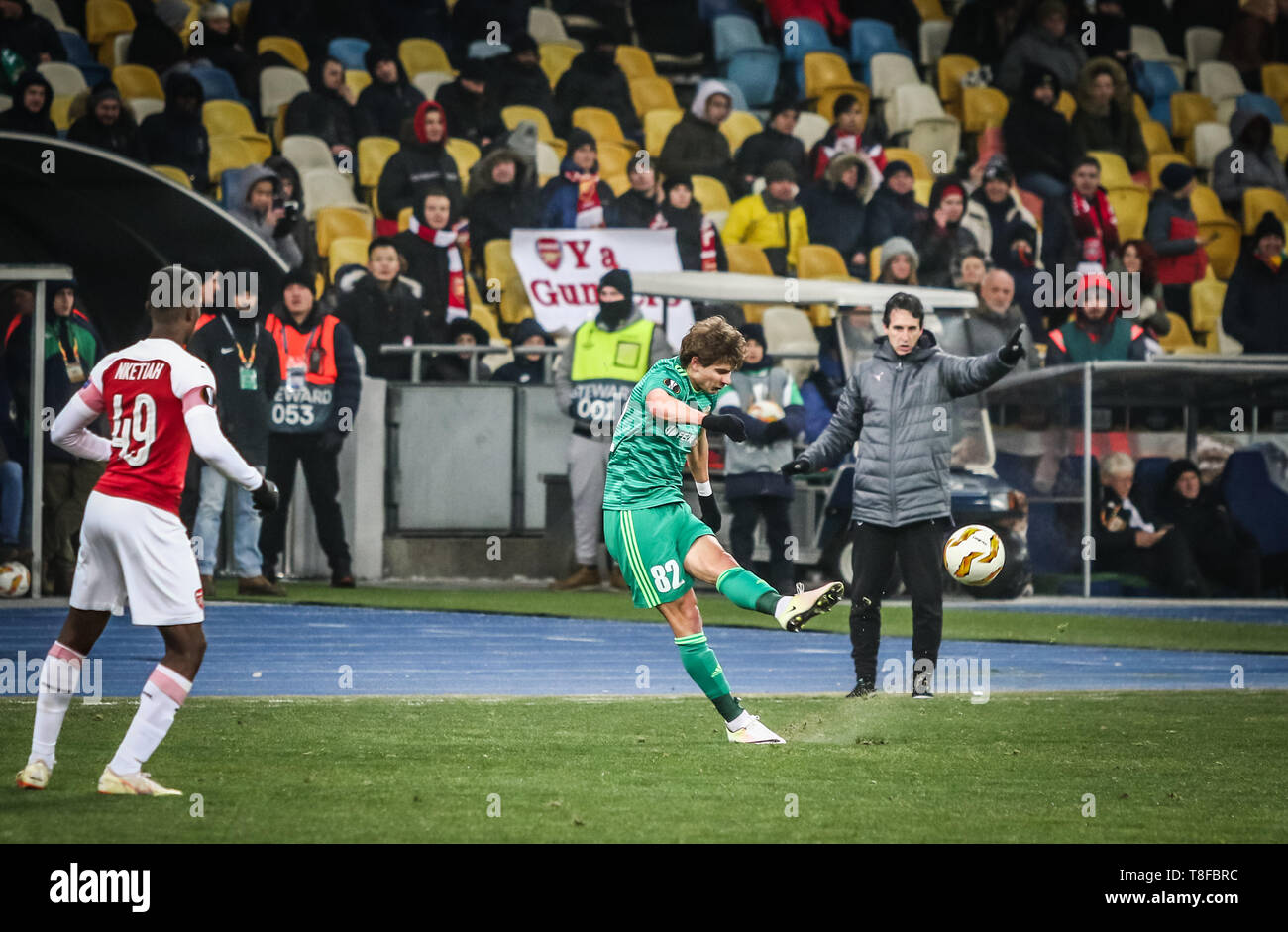 KYIV, UKRAINE - NOVEMBER 29, 2018: Pavlo Rebenok of FC Vorskla Poltava (in Green) kicks a ball during the UEFA Europa League game against Arsenal at N Stock Photo