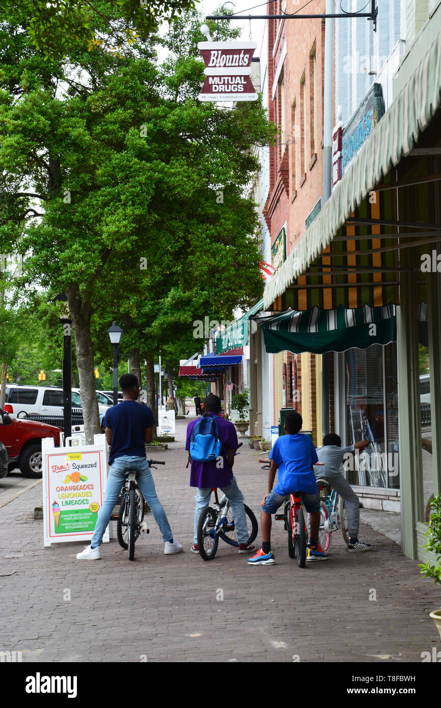 Several kids stop for ice cream cones at an old fashion drug store in