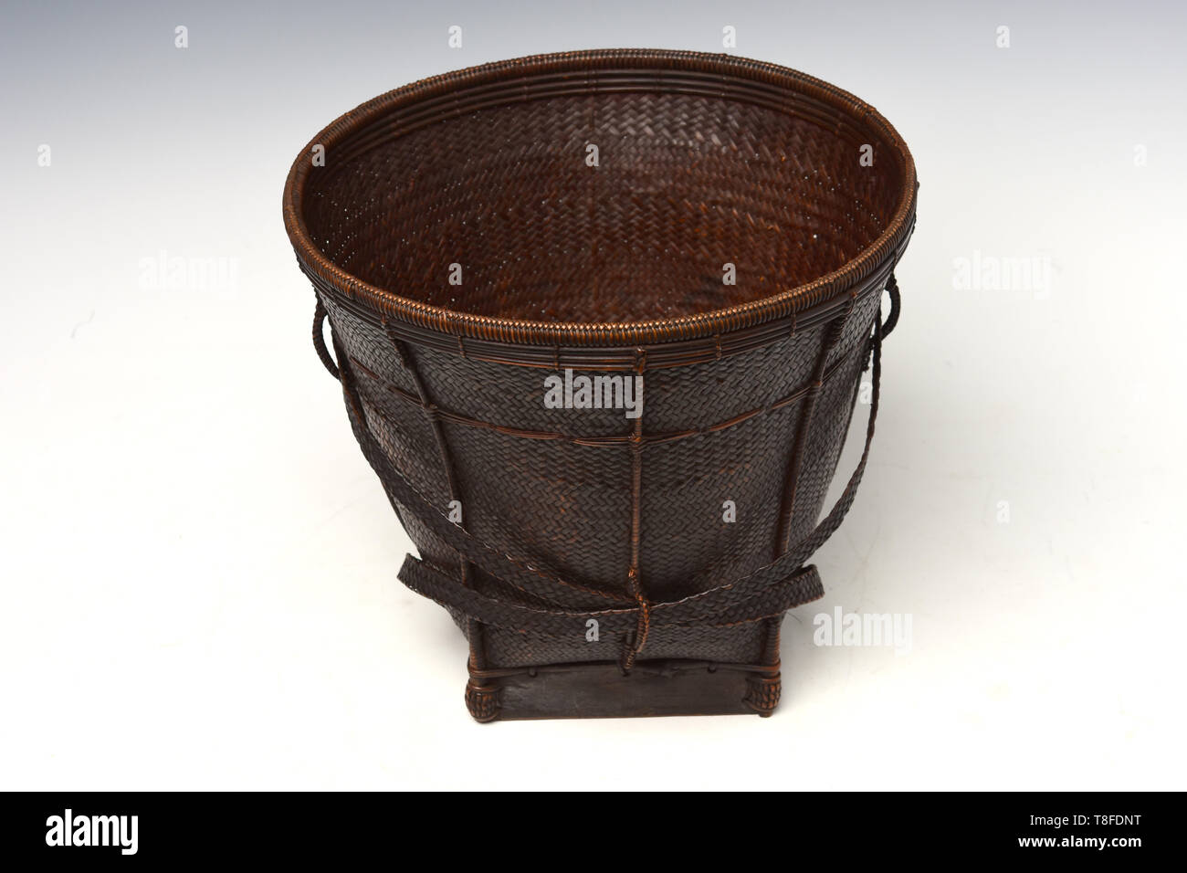 antique brown wicker basket on gradient background Stock Photo