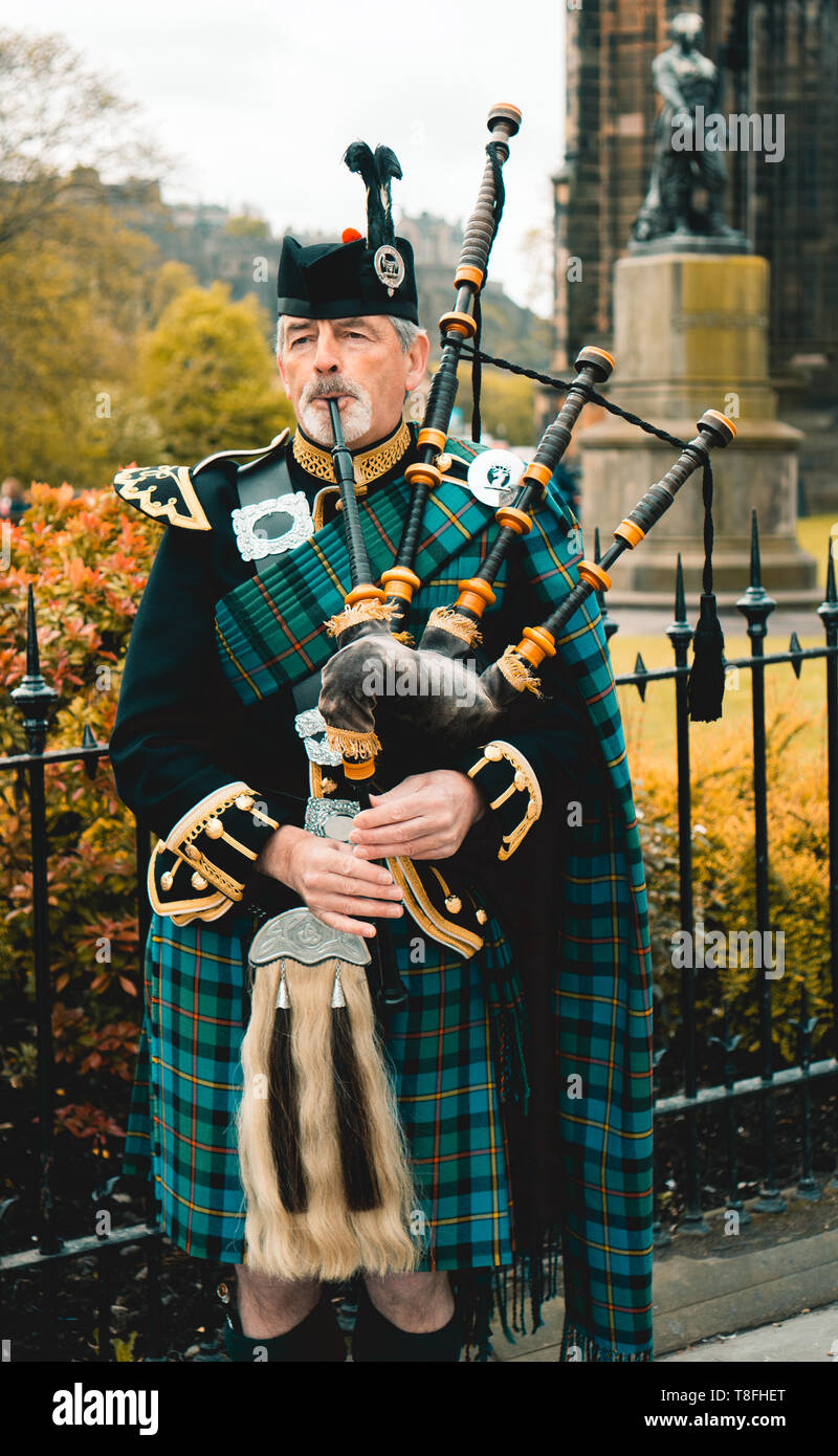 Traditional scottish bagpiper in full dress code in Edinburgh Stock Photo