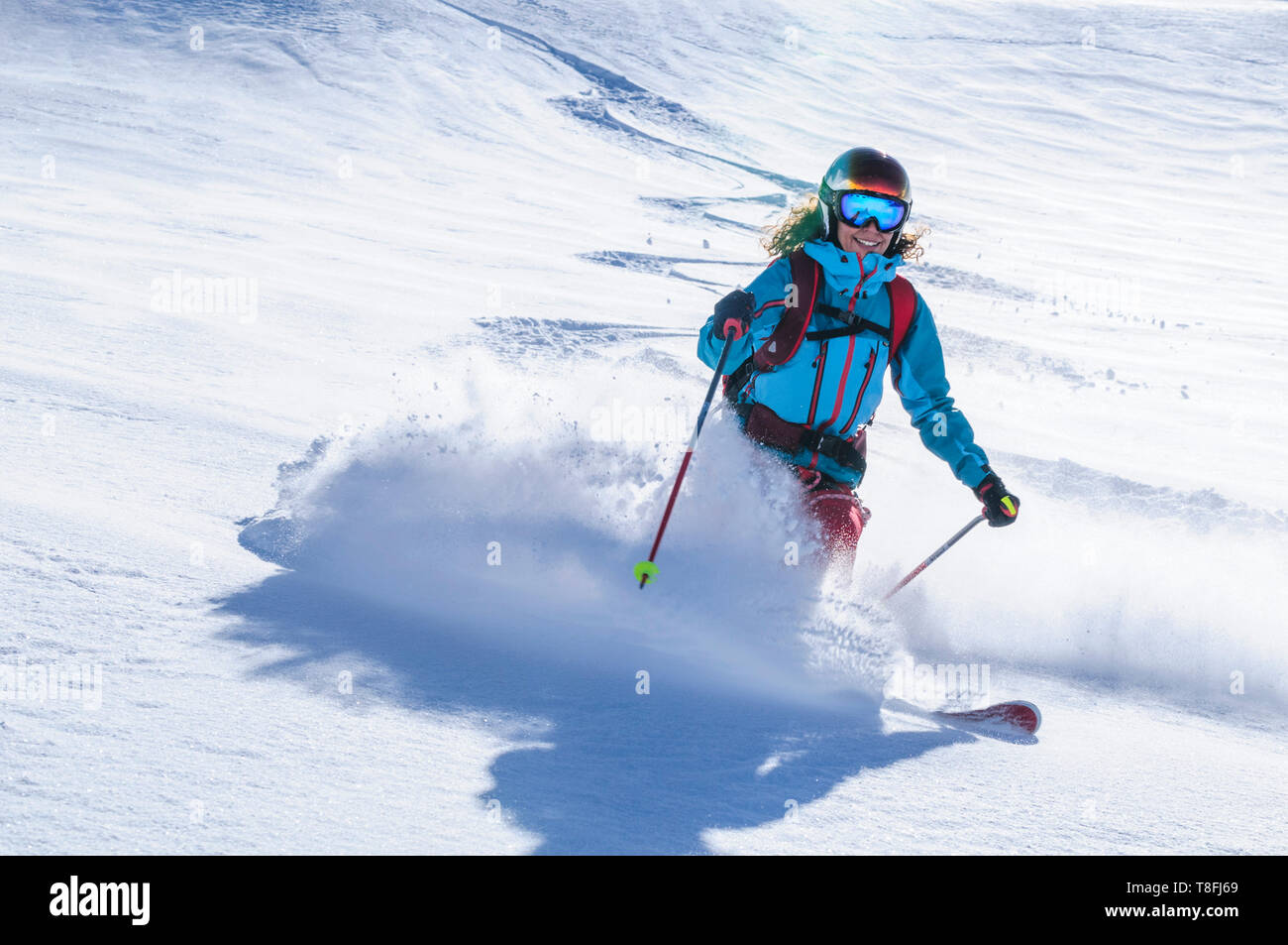 Female freeskier skiing in backcountry on fantastic Monte Rosa glaciers Stock Photo