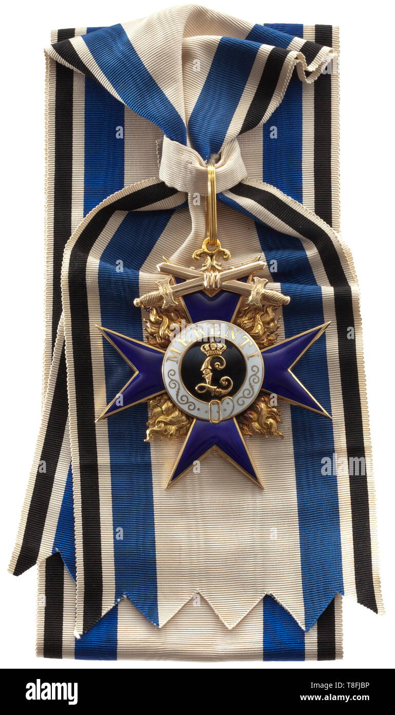 A Grand Cross with Swords of the Bavarian Military Merit Order Cross of the Order in Gold from the pre-1917 period of the First World War. The award, produced by the Hemmerle Brothers in Munich, is marked 'GEB.H. 750' in the lower cross arm. Between the hollow wrought, blue enameled cross arms the flames are individually inset and finely re-engraved in order to amplify their fire. The three-section medallion is white and black enameled. The swords, likewise hollow hand-wrought and completed on both sides, are affixed at their cen 20th century, Additional-Rights-Clearance-Info-Not-Available Stock Photo