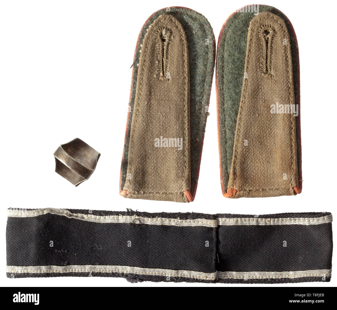 A cuff title, a pair of shoulder boards and a commemorative ring - Africa Corps The cuff title with black base cloth, stitched silver lace, machine-woven legend 'Afrikakorps', the ends stitched, total length circa 34 cm, width 35 mm. Also a pair of shoulder boards for enlisted men of beige linen cloth with field grey underlay, piped in pink for Panzer troops members, with loops, the slots separately stitched. Included is a silver ring with a stylised palm of the 'DAK 1941' and swastika, the sides with oriental décor, weight 11 g. Inner diameter 2, Additional-Rights-Clearance-Info-Not-Available Stock Photo