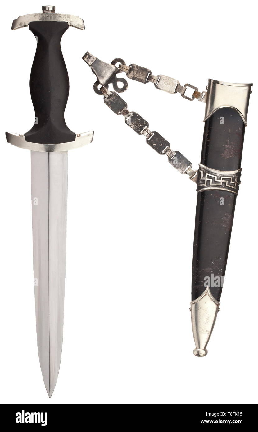 A service dagger M 36 with chain hanger The blade with etched motto, nickel-silver cross-guards, top lower reverse stamped '?17'. Black wooden grip with inset nickel-silver eagle and enamelled SS emblem. Black burnished steel scabbard. Plated chain with typical 'SS' stamping. Traces of age and usage, Length 37 cm. historic, historical, 20th century, 1930s, 1940s, Waffen-SS, armed division of the SS, armed service, armed services, NS, National Socialism, Nazism, Third Reich, German Reich, Germany, military, militaria, utensil, piece of equipment, utensils, object, objects, s, Editorial-Use-Only Stock Photo