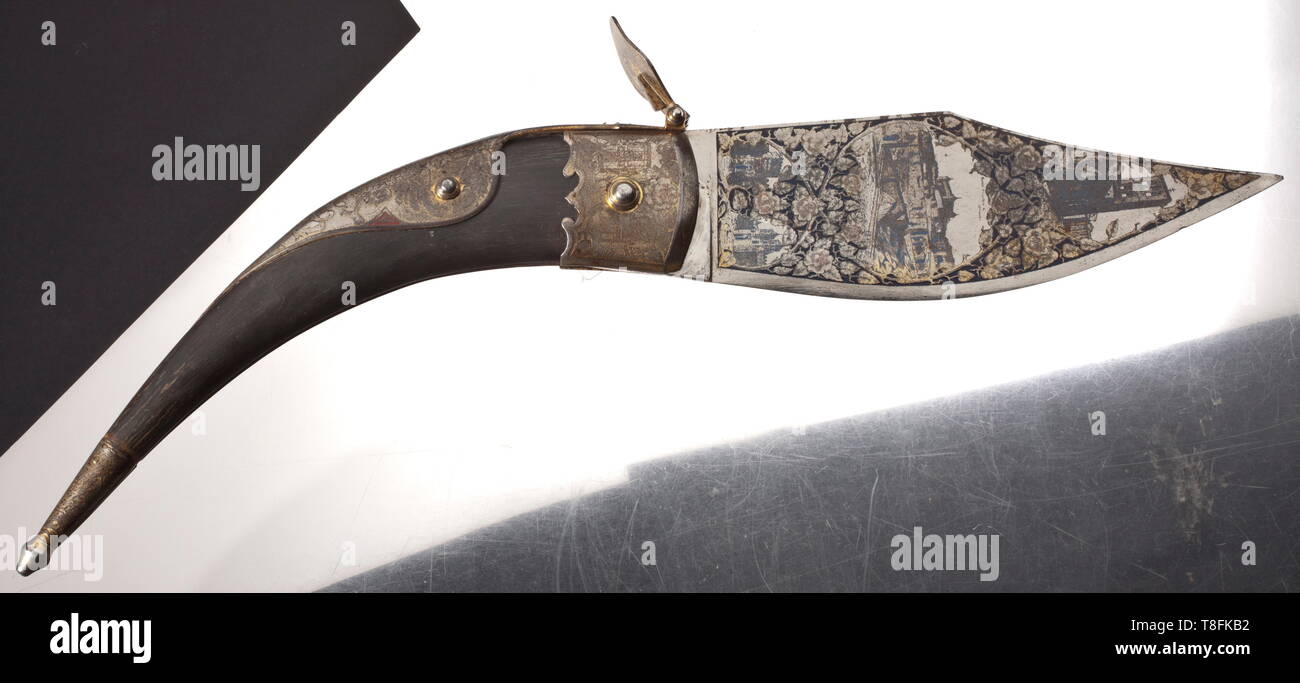 Oberst Werner Mölders - a large Toledo Navaja from his time in the Condor Legion Powerful blade (stained), profusely etched on all surfaces with partly blued, partly gilt (faded) depictions of the "Puente de Alcántara", the "Alcazar", and the "Catedral" as well as the city gates "Puerta de Bisagra", "Puerta de Alfonso VI", "Puerta del Cambron" and the "Puerta del Sol". Large cowhorn grip with further etched townscapes with vestiges of gilding, the reverse with the royal Spanish coat of arms. The push piece for the snap lock with maker´s etching "Felipe Suarez - Hombre de Pa, Editorial-Use-Only Stock Photo
