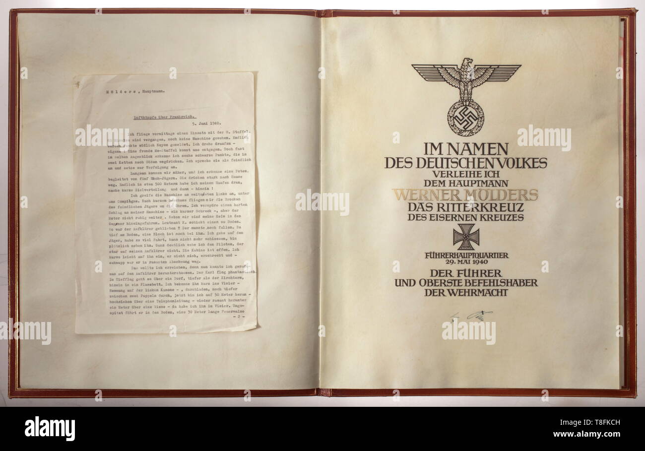 Oberst Werner Mölders - a large award document for the Knight's Cross of the Iron Cross The award document, issued to Hauptmann Werner Mölders, is dated 'FÜHRERHAUPTQUARTIER DEN 29. Mai 1940' and bears the original signature in ink of Adolf Hitler. A difference between this and the usual award documents is that here the text page is bound into a double-sided parchment sheet. The handwritten document text is rendered in brown-black ink, and the wearer's name is applied in raised gold lettering. The document is situated in a folder of red Morocco leather with a gold, stamped , Editorial-Use-Only Stock Photo
