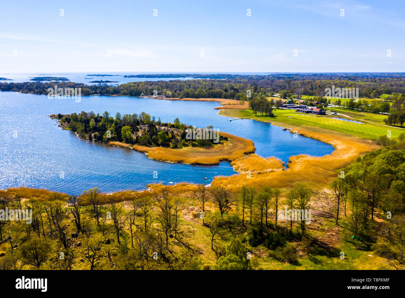 Blekinge archipelago outside the island Almo in Sweden on a fine spring day. Seaside golf course visible to the right. Stock Photo