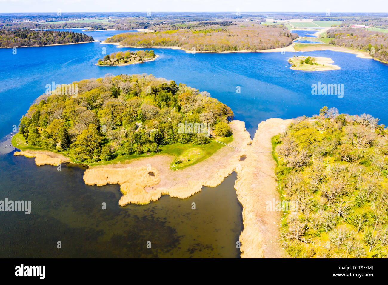 Aerial of Blekinge archipelago in Sweden on a sunny spring day. The small island Betesholmen outside Ronneby with view over Vambasa. A hiking trail le Stock Photo