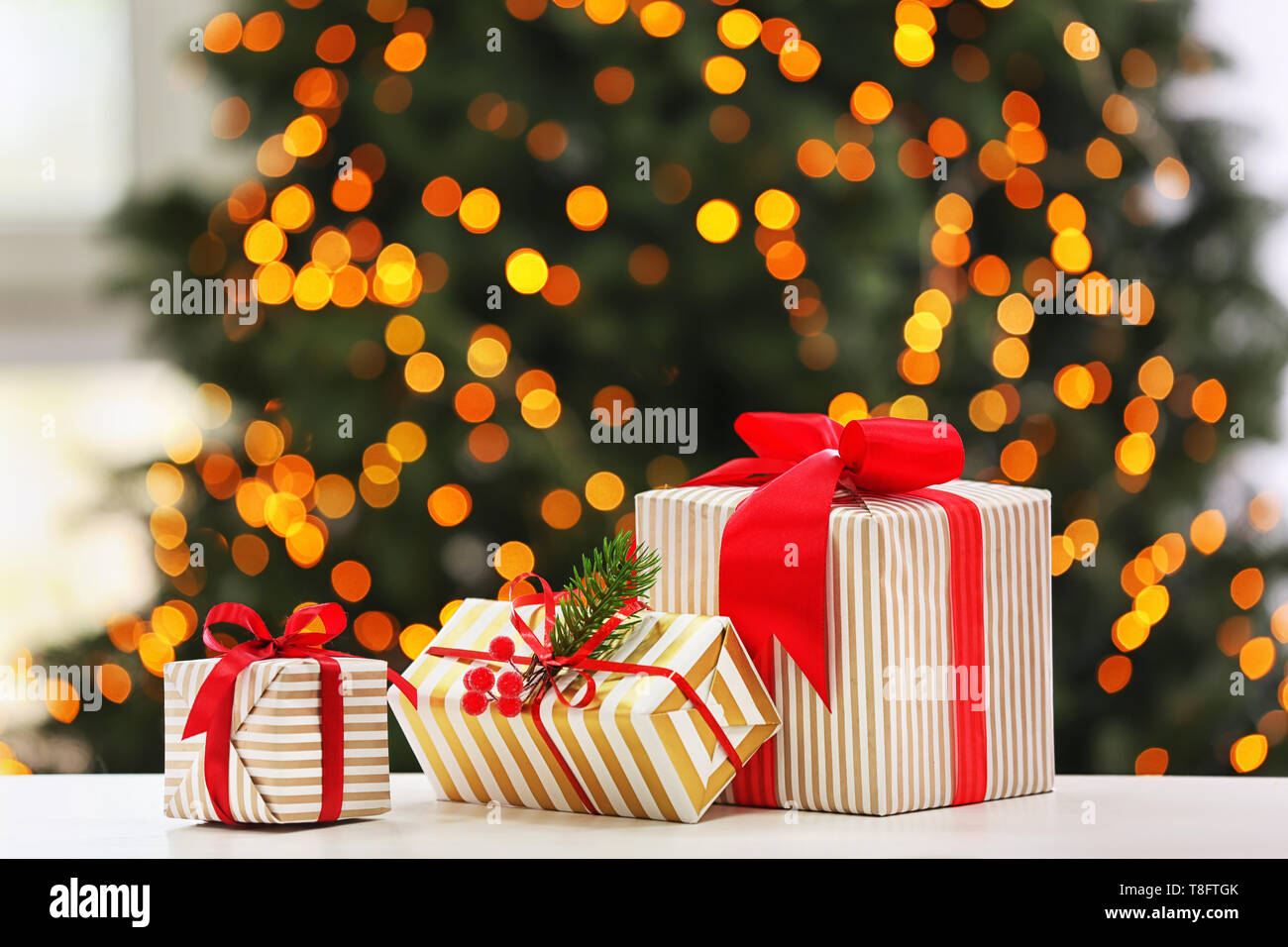 Christmas gifts on table in room Stock Photo - Alamy