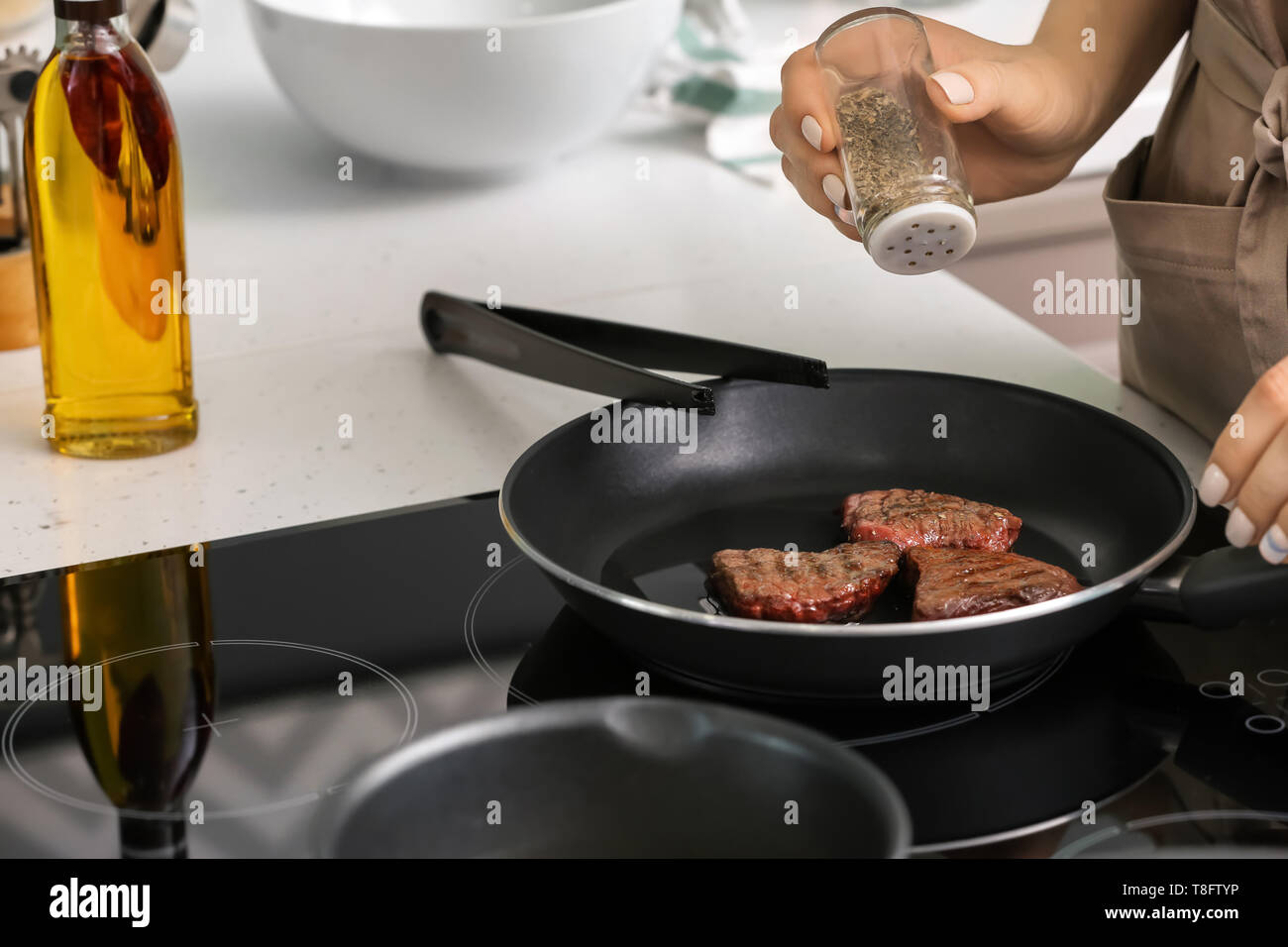 Adding spices meat dish cooking hi-res stock photography and images - Alamy