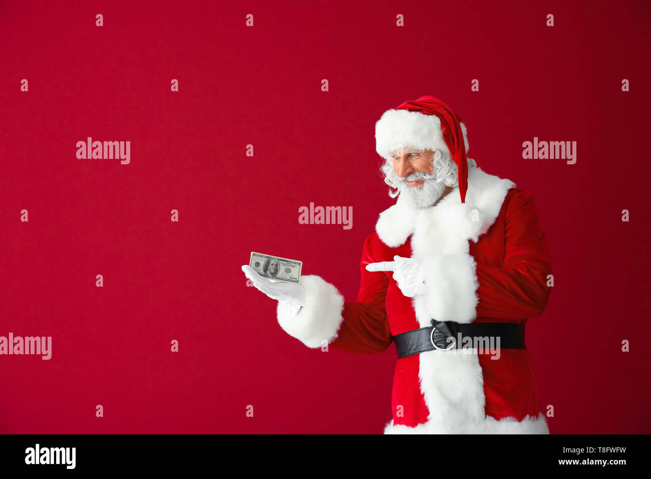 Santa Claus with dollar banknotes on color background Stock Photo - Alamy