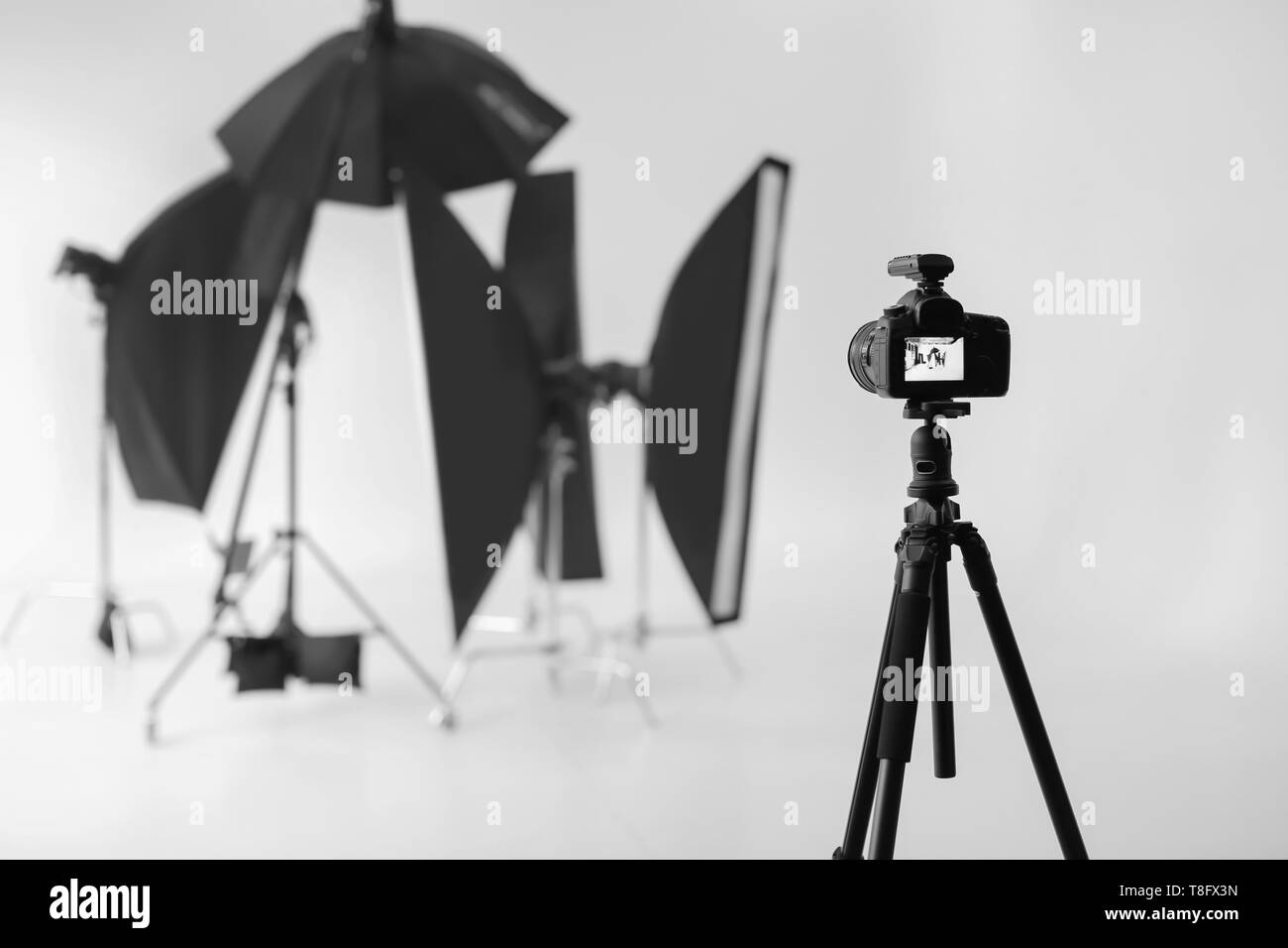 Professional camera on tripod in photo studio Stock Photo Alamy