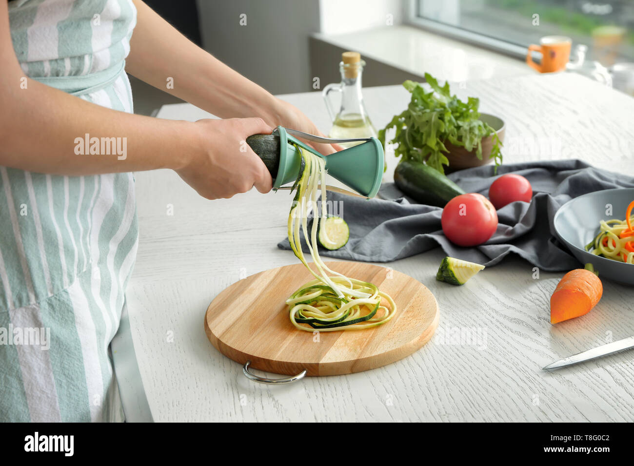 Woman making zucchini spaghetti Stock Photo