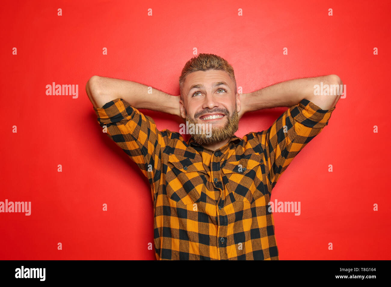 Portrait Of Handsome Man With Dyed Hair And Beard On Color