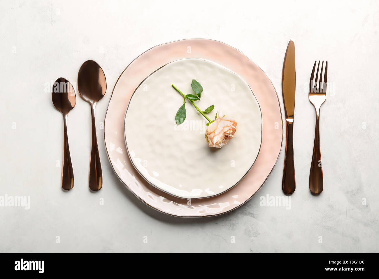 Table setting for one person on light background Stock Photo - Alamy