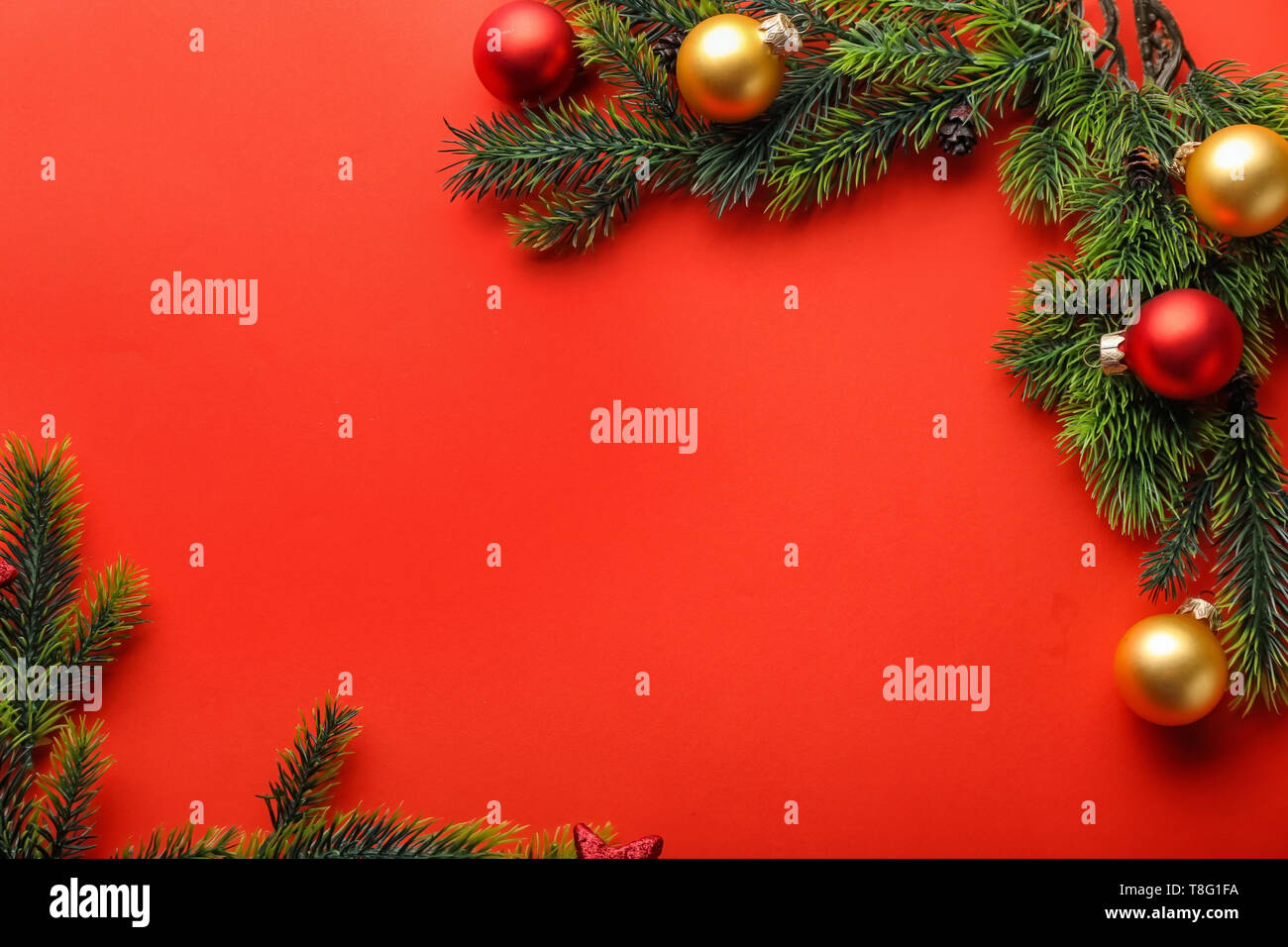 Christmas tree branches and balls on color background Stock Photo - Alamy