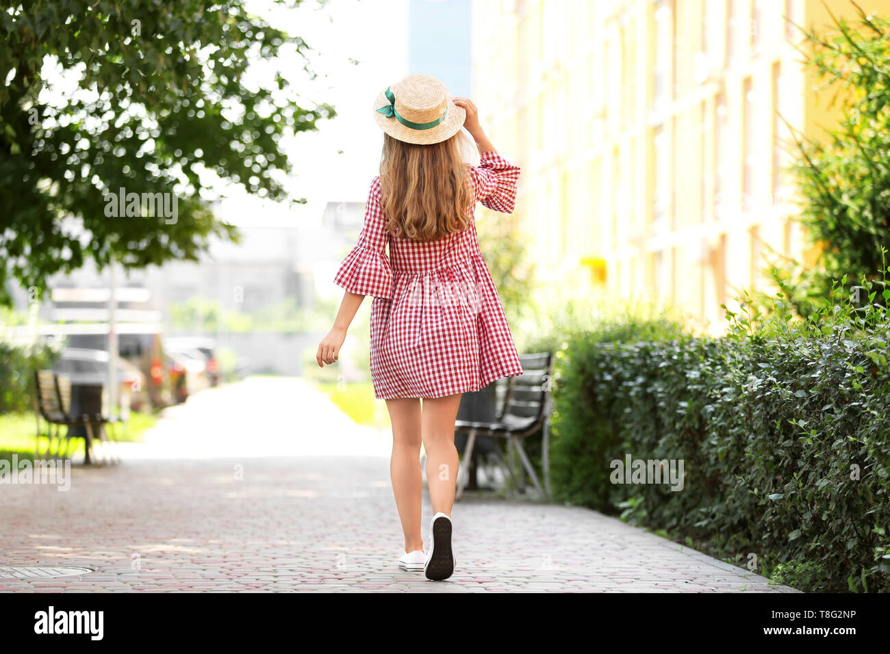 Beautiful young woman walking in park Stock Photo - Alamy
