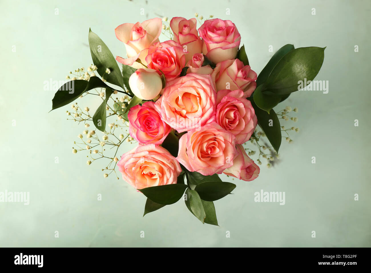 Bouquet of beautiful roses on light background Stock Photo - Alamy