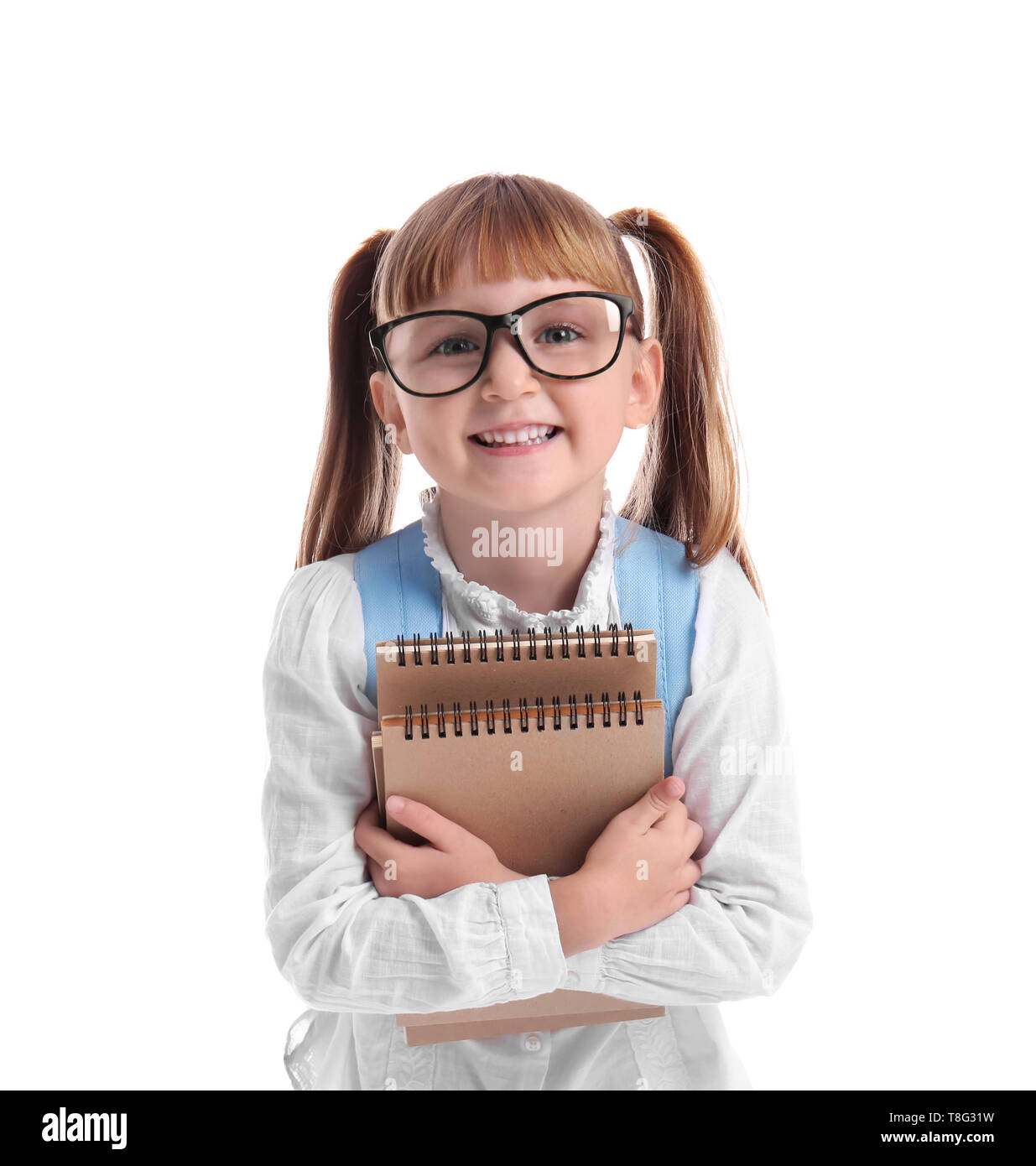Cute little schoolgirl with notebooks on white background Stock Photo ...
