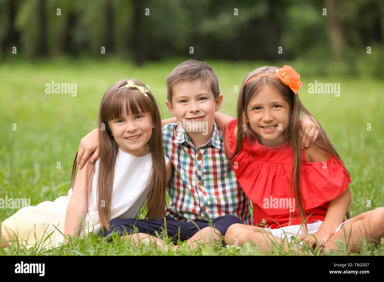 Cute little children in park on summer day Stock Photo