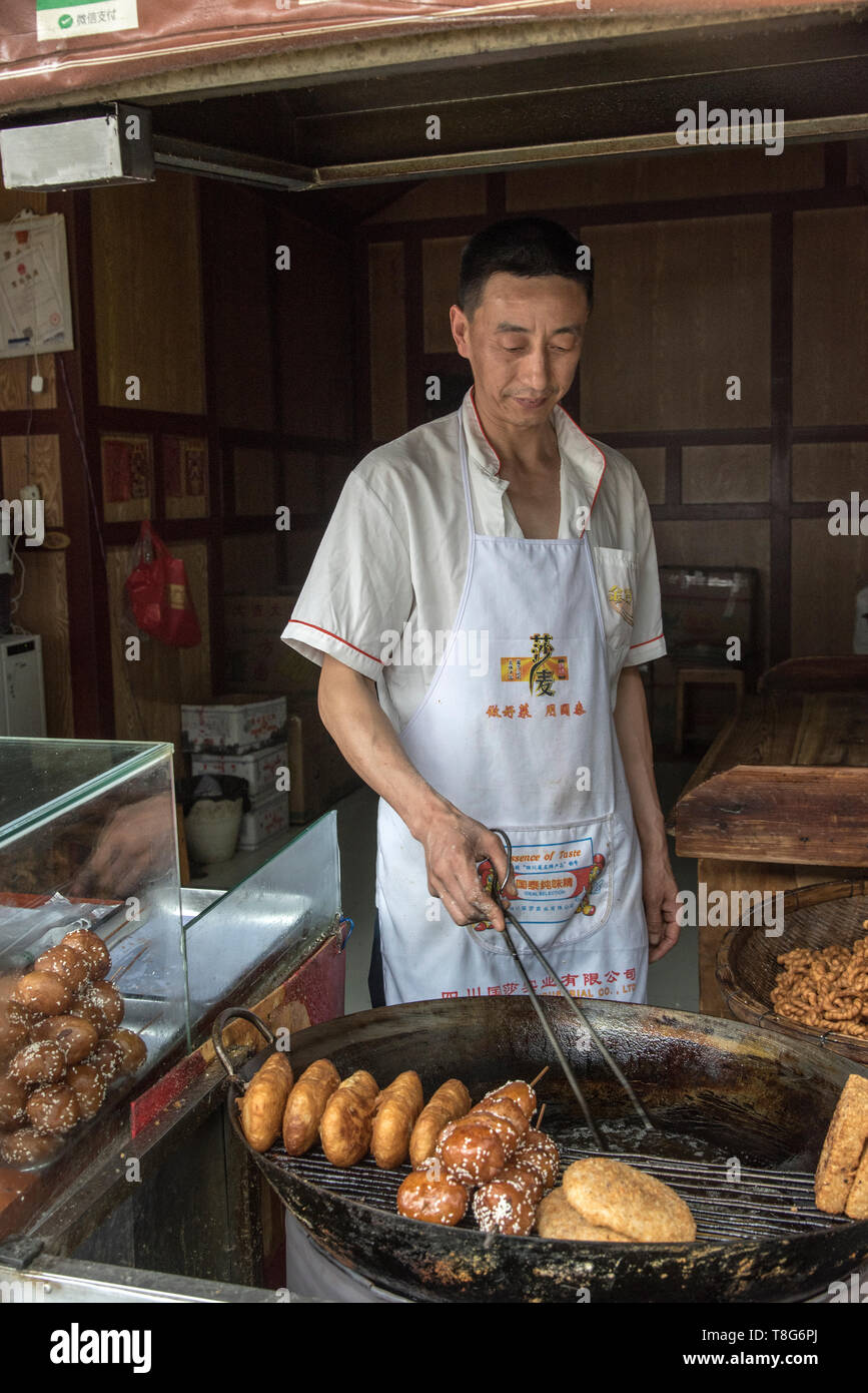 Chinese Street food. Food vendor sells food at a stall in  Sichuan, China Stock Photo