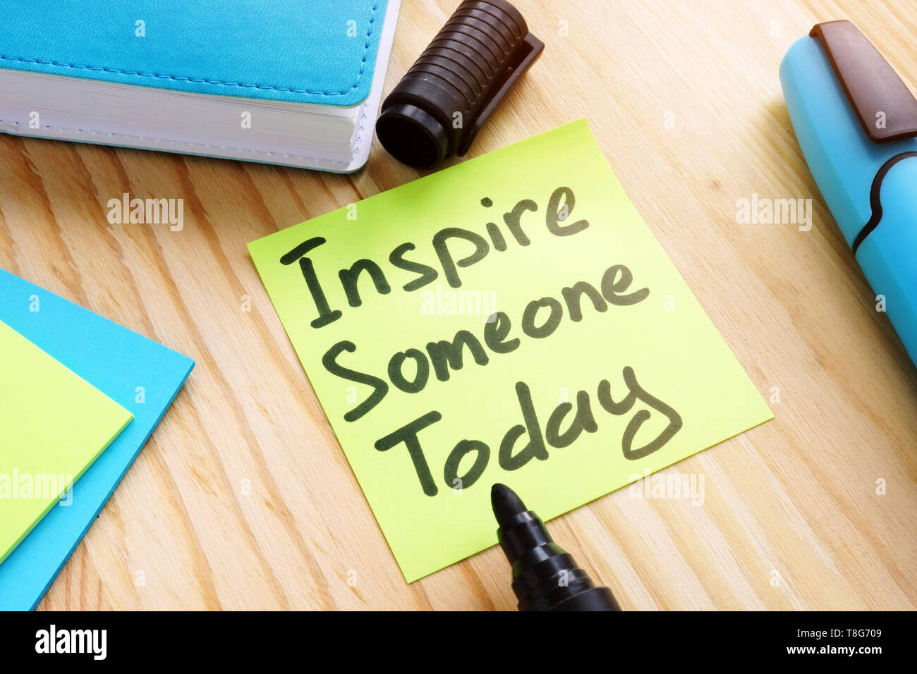 Quote Inspire someone today on desk. Inspiration concept. Stock Photo
