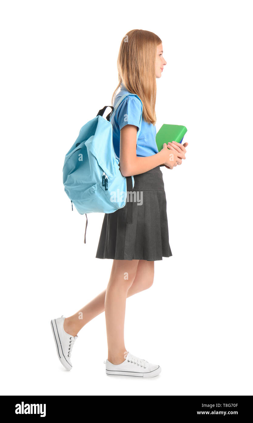 Cute schoolgirl with books against white background Stock Photo - Alamy