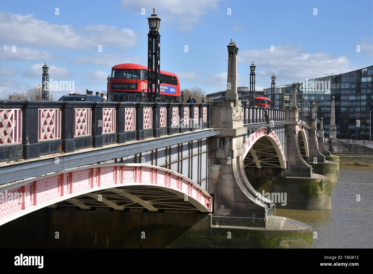 Red London Bus crossing over Lambeth Bridge, Westminster, London. UK Stock Photo