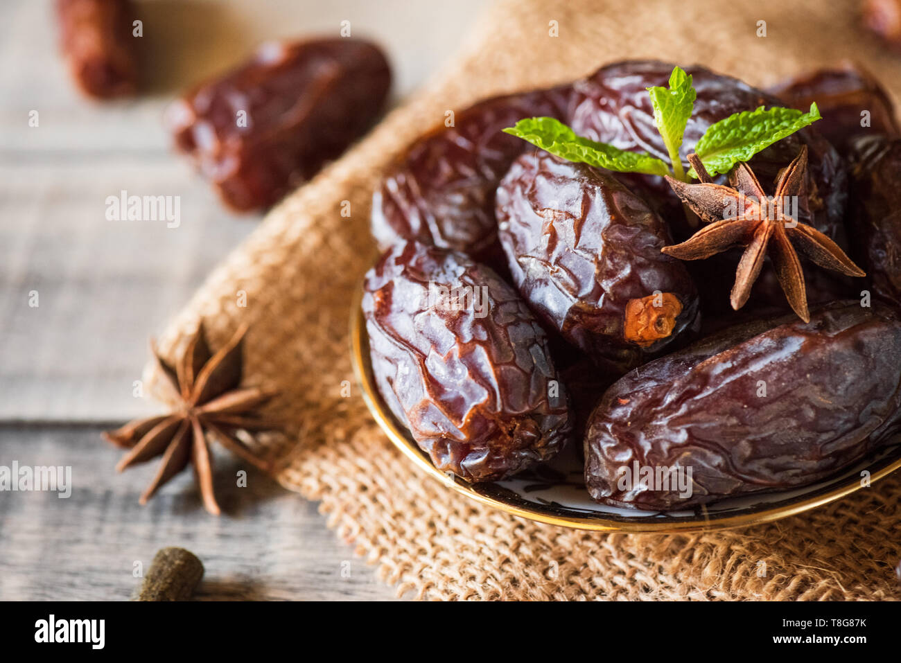 Ramadan food and drinks concept. Dates fruit and green Mint leaves in a