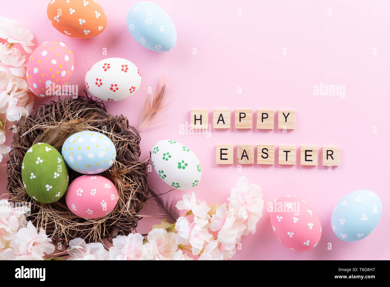 Happy easter! Colorful of Easter eggs in nest with flower and Feather ...