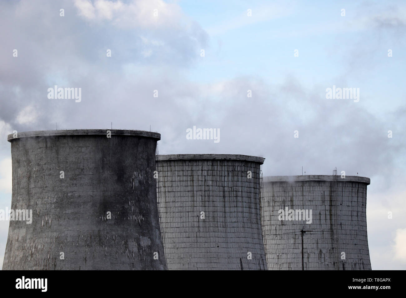 Air pollution, smoking pipes on blue sky background. Factory chimneys, concept of chemical industry and ecology, steam plant, global warming Stock Photo