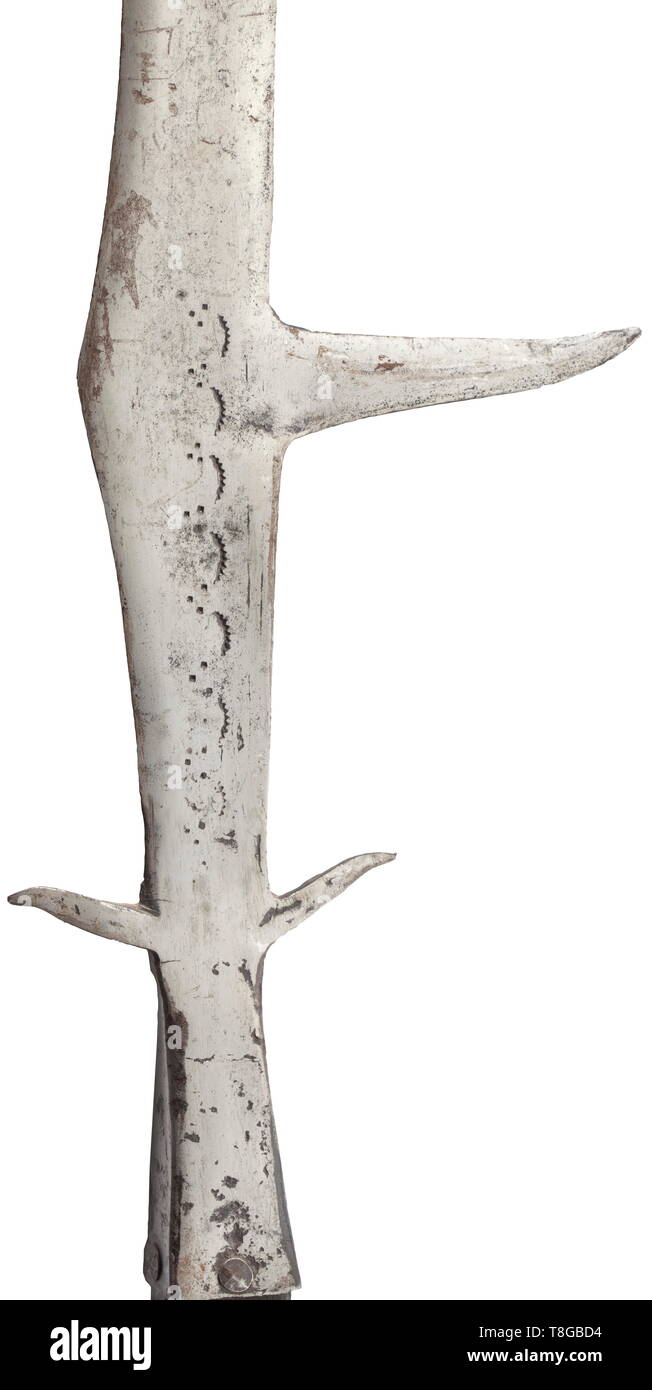 An Italian bill (roncone), circa 1520-30. The head flattened throughout, formed with the lower leading edge coming to an apex at its centre, drawn up to a curved double-edged blade and prolonged by a central double-edged spike, the lower portion of the back edge remaining blunt below the dorsal fluke, punched on both sides with a vertical row of so-called eyelash marks punctuated by triangular groups of small rectangular punches, with a pair of short recurved lugs at the base, and short rectangular socket fitted with a pair of iron straps (the st, Additional-Rights-Clearance-Info-Not-Available Stock Photo