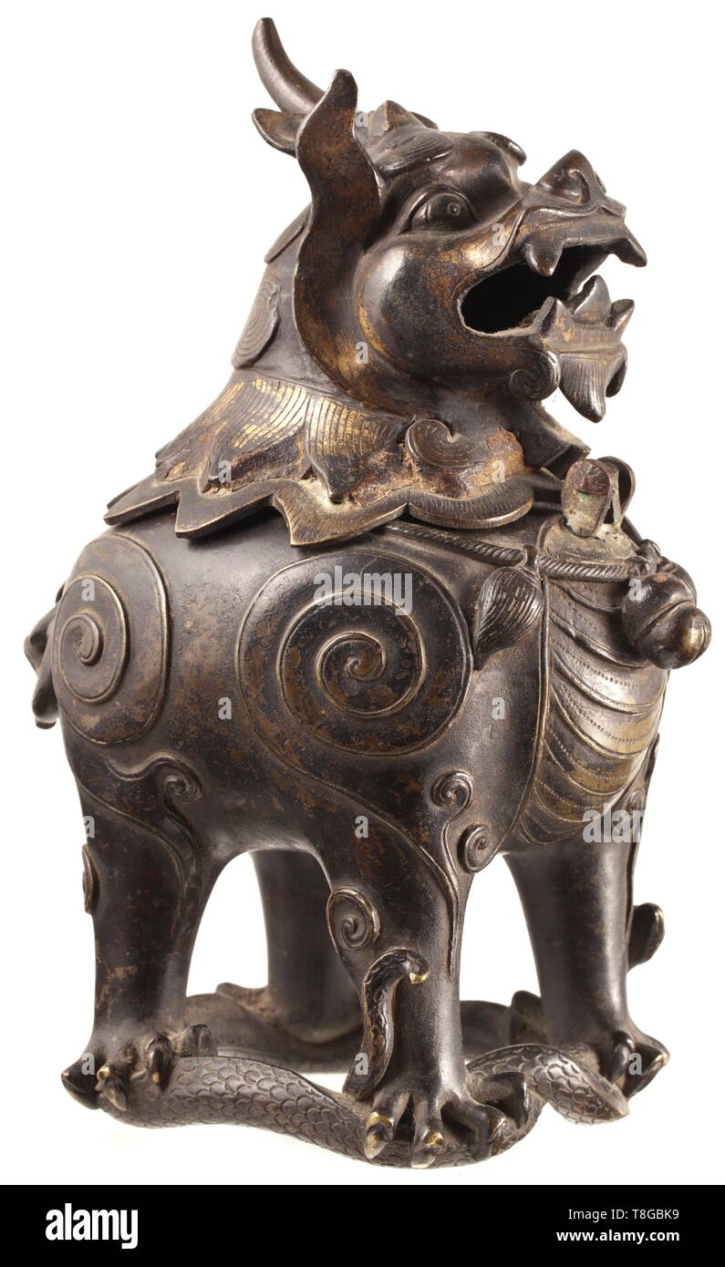 A Chinese censer in the form of a qilin 19th century. Bronze with remains of gilding. Portrayal of a qilin-like mythical creature, resting with its four claws on a snake. The head of the creature as censer lid connected to the body by a (damaged) hinge. Height 20 cm. historic, historical, China, Chinese, 19th century, Additional-Rights-Clearance-Info-Not-Available Stock Photo