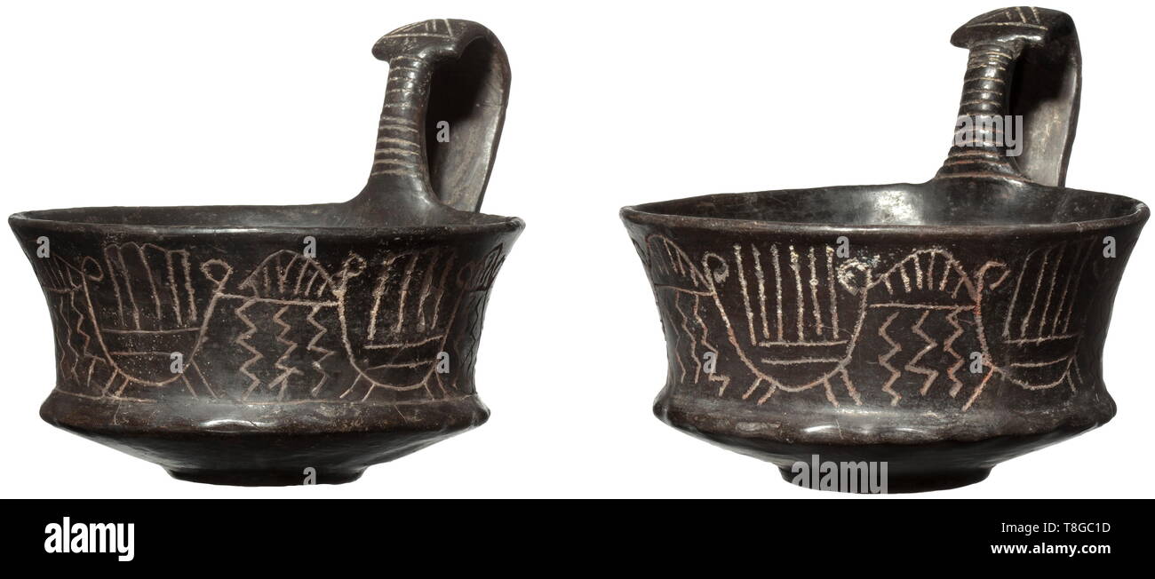 Two Etruscan bowls with handles, 5th century BC Red clay fragment with black lustre coating. Tapered drinking bowls with slim foot and handles that are hoisted on the sides. The body and the handles with geometrical carving decorations on the outside. Each has been professionally assembled from clay fragments. Diameter 10.7 and 11 cm. Provenance: Private collection in Kassel, 1960s. historic, historical, ancient world, ancient times, Greek, Hellas, ancient world, Additional-Rights-Clearance-Info-Not-Available Stock Photo