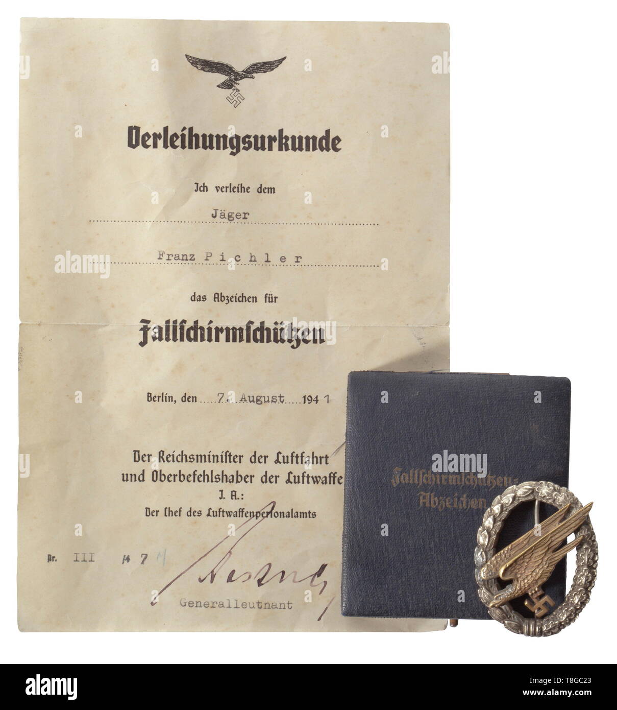 A Badge for Parachutists in its case and award document The badge in silvered non-ferrous metal with gilt eagle, which is double-riveted (repaired) with maker´s mark 'Imme & Sohn, Berlin'. Open worked swastika and attachment pin system with thin needle. In its case, the interior lined with blue velvet and silk, the top with gold lettering 'Fallschirmschützen=Abzeichen'. Included is the award document (folded) to awardee Jäger Franz Pichler, issued on 7 August 1941 with original signature of Generalleutnant Kastner. With signs of age and usage. historic, historical, awards, , Editorial-Use-Only Stock Photo