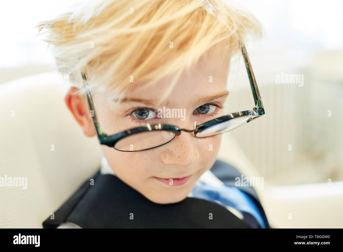 Boy with glasses as a smart pupil or student or businessman in the office Stock Photo