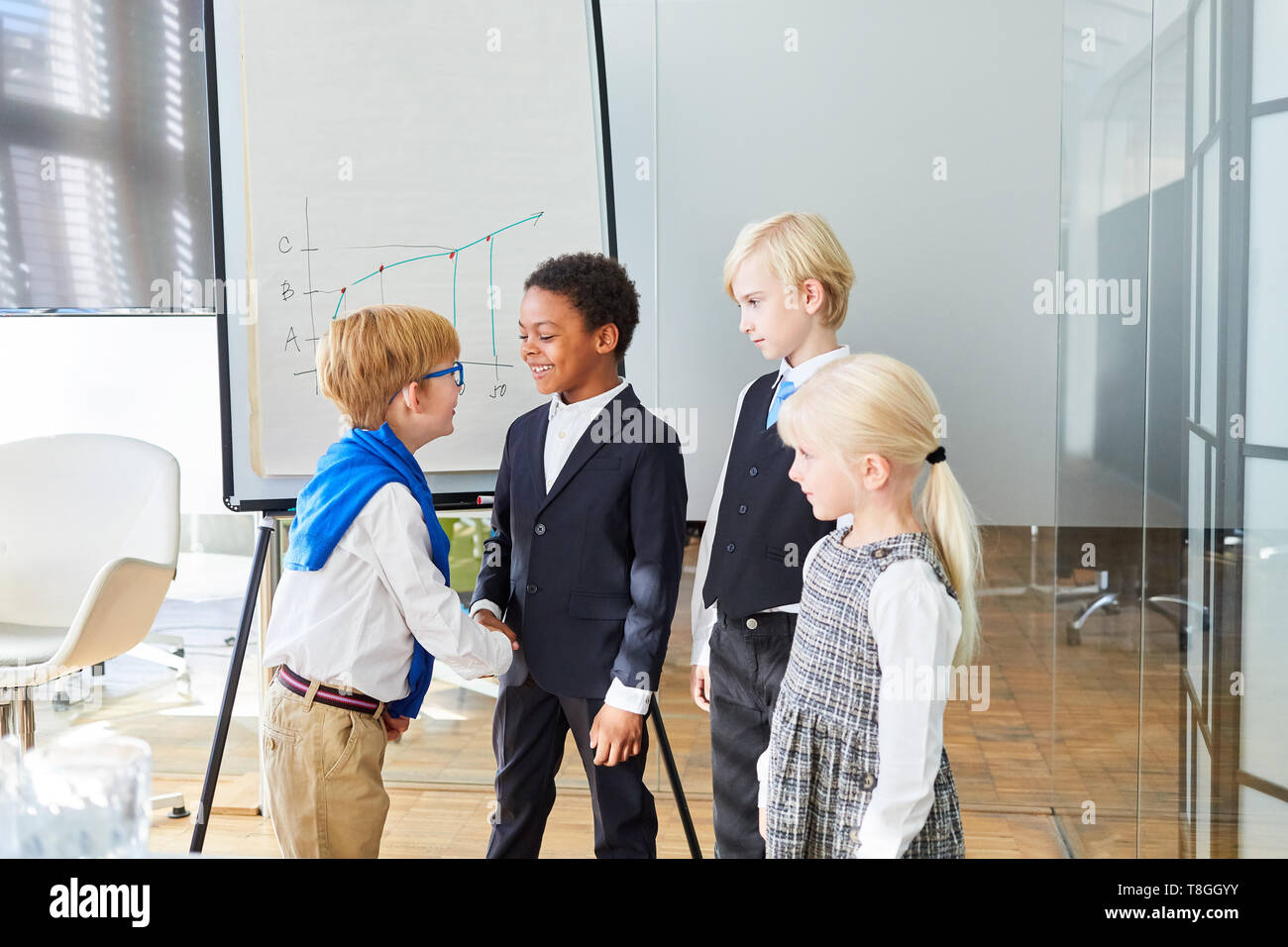 Business kids greet each other with a handshake before the negotiations in the office Stock Photo