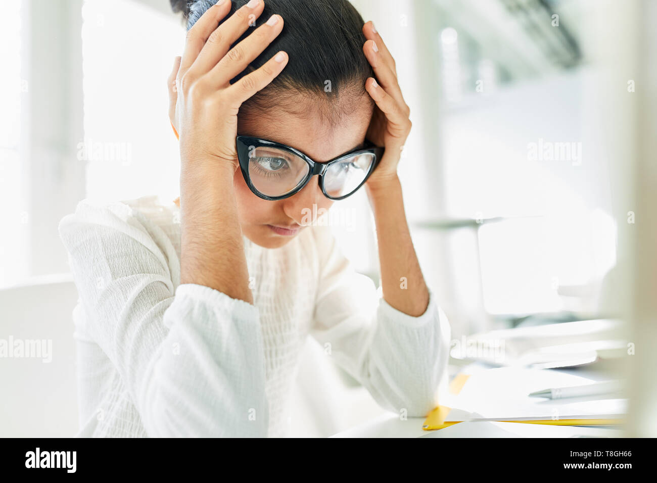 Girl as a student or businesswoman thinking about a problem Stock Photo