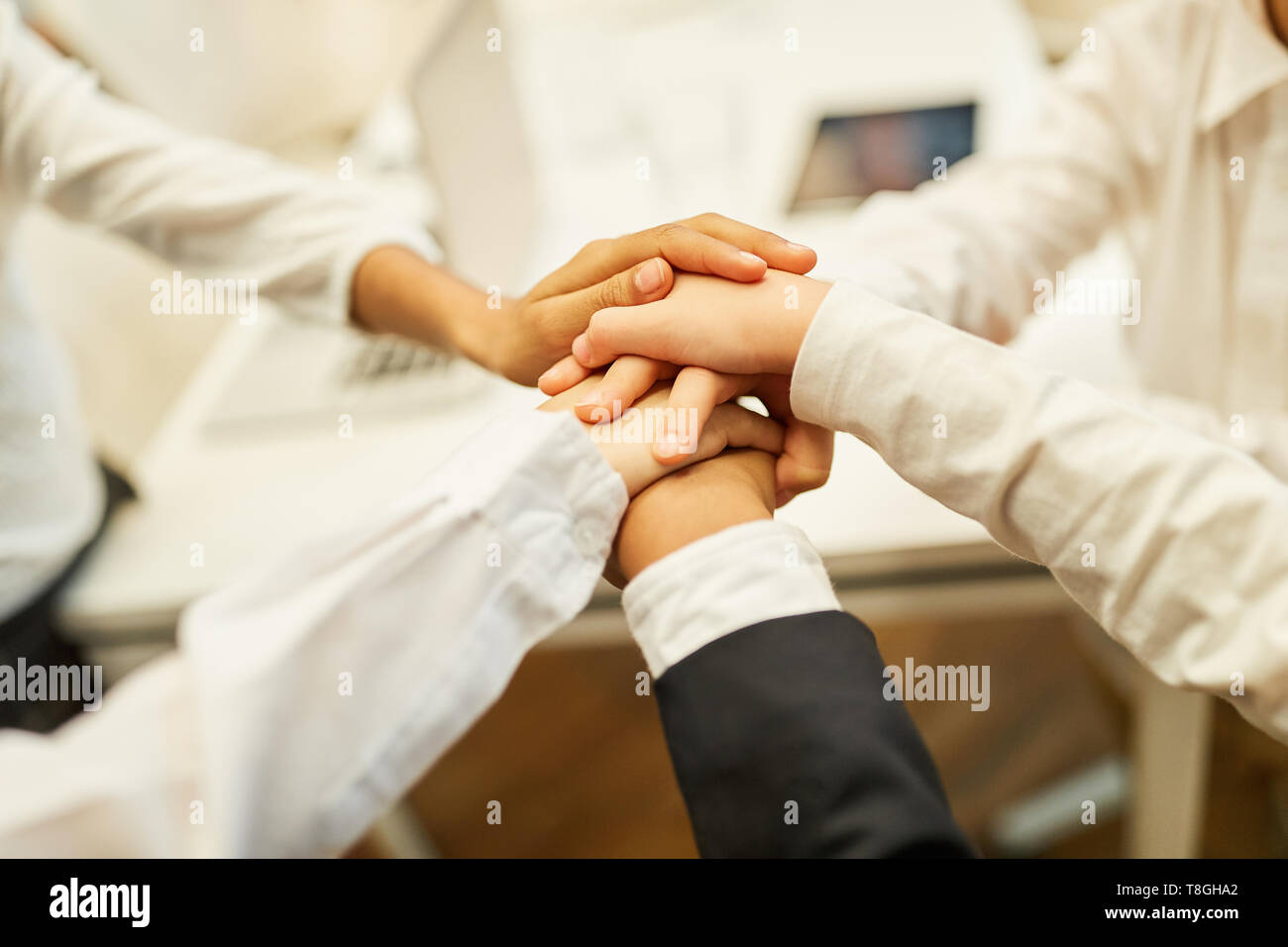 Business people stack hands as a concept for teambuilding and network ...