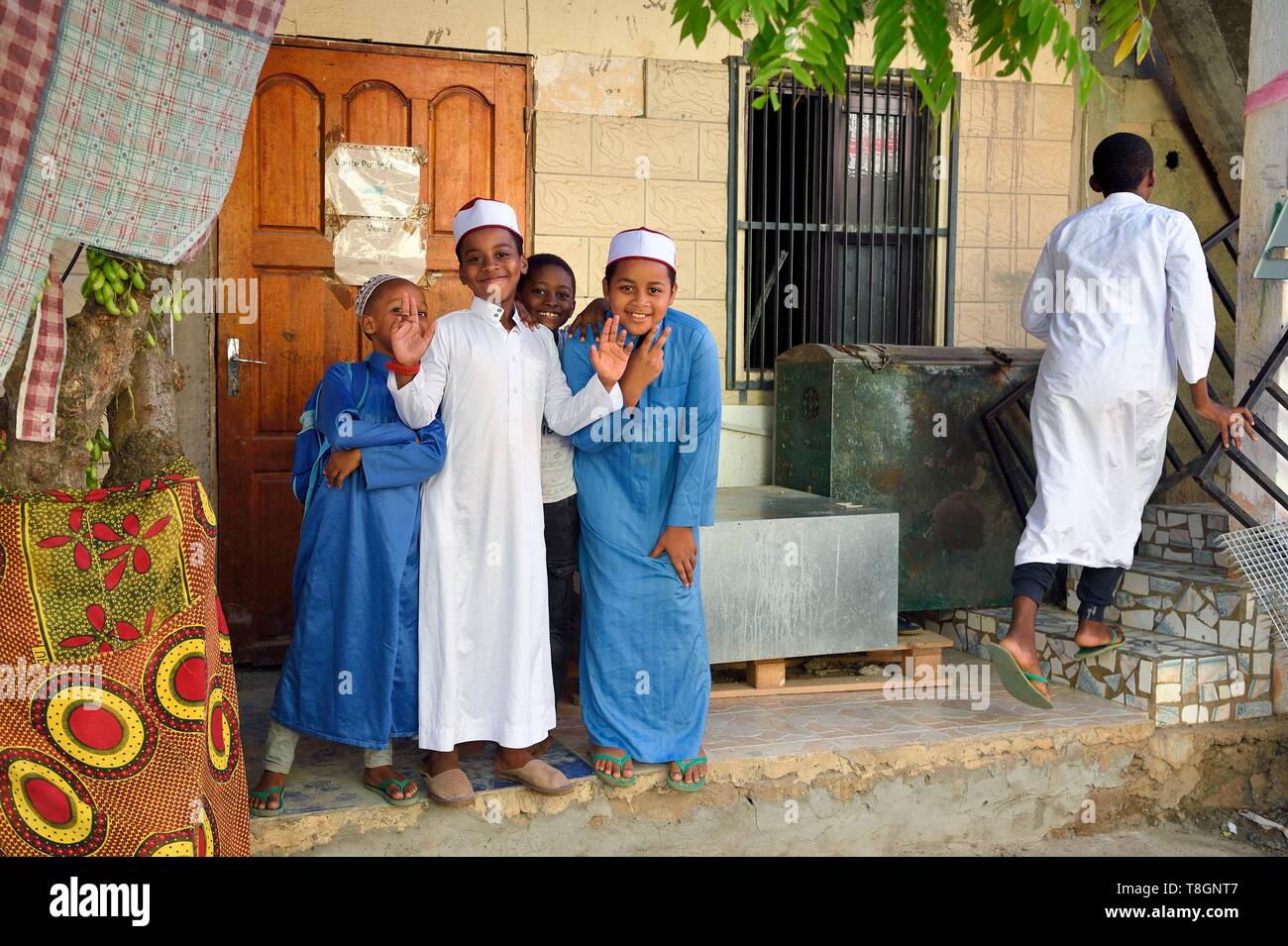 France, Mayotte island (French overseas department), Grande Terre, Sada, children wearing an embroidered kofia, traditional Comoran hat, coming out of the madrassa Stock Photo
