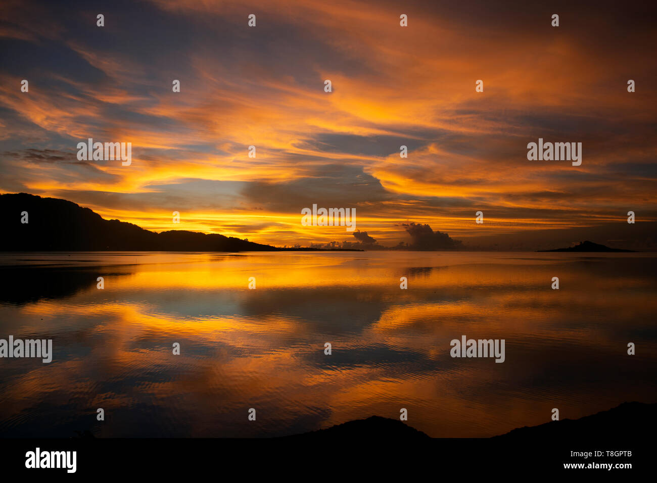 Golden sky with clouds at sunset, U district, Pohnpei, Federated States of Micronesia Stock Photo