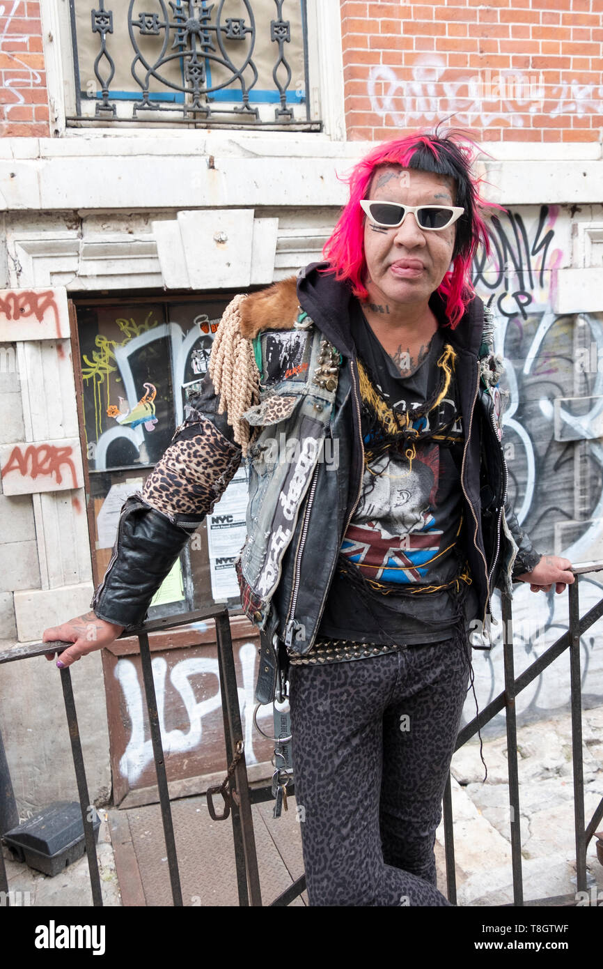 Posed portrait of Astro Erle, nightlife icon, club kid and hairstylist,. On St. Marks pLace in the East Village, New York City. Stock Photo