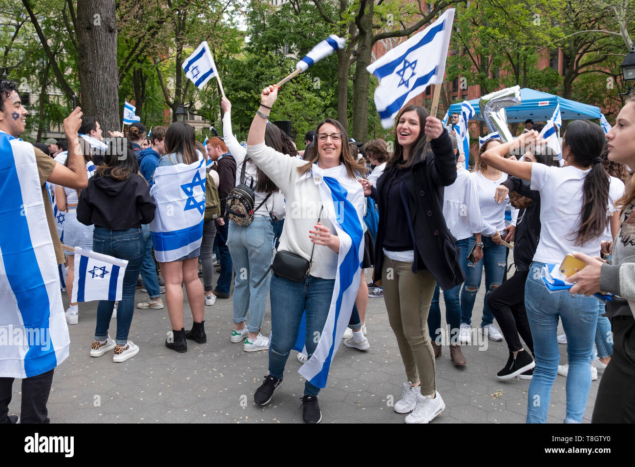 An Israeli & American young lady dance happily at the Israel Independence Day celebration in Washington Square Park in Manhattan,  NYC. Stock Photo
