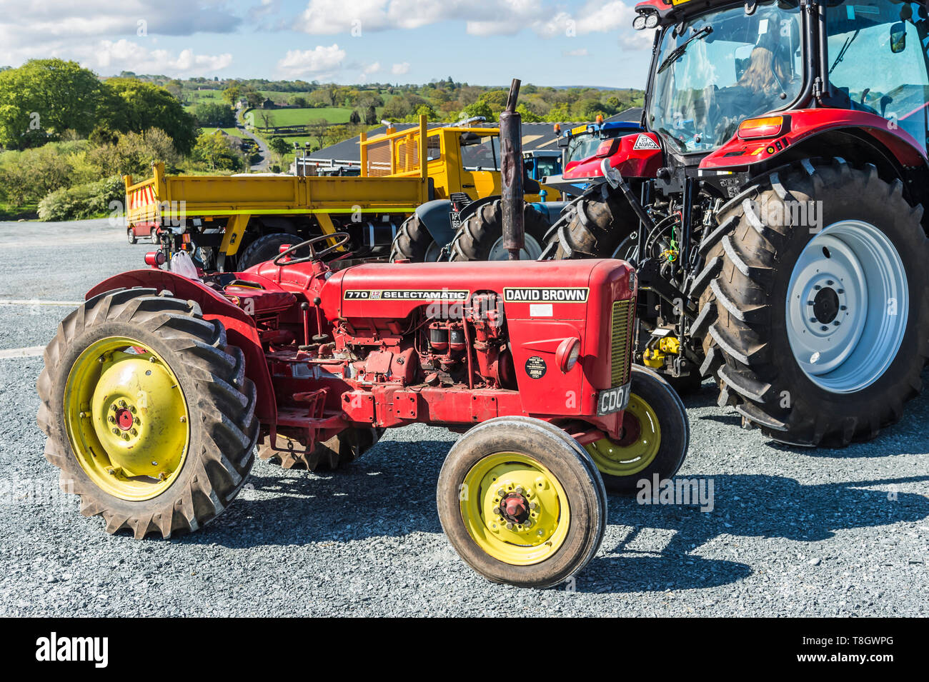 Farm tractors old and new on parade at High Bentham Auction Yard prior to the start of the