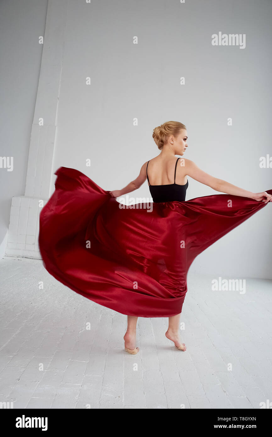 A gymnast in a dark top and a red silk skirt. The color of passion, of ...
