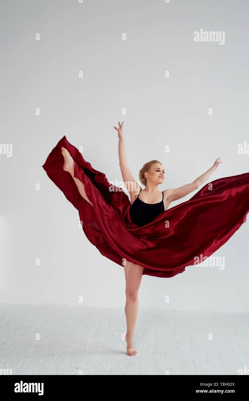 A gymnast in a dark top and a red silk skirt. The color of passion, of ...