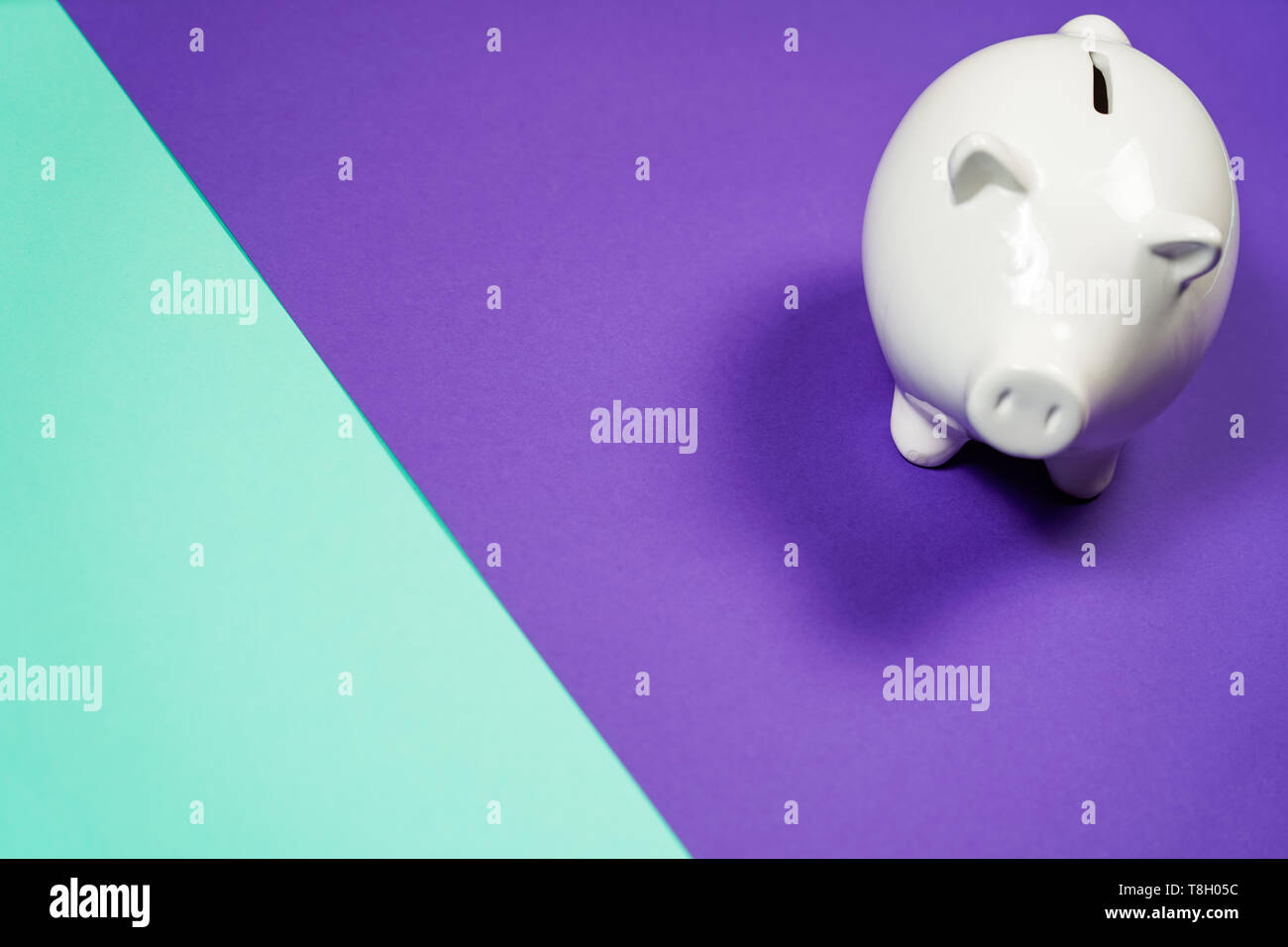 White Piggy bank isolated on purple background Stock Photo - Alamy