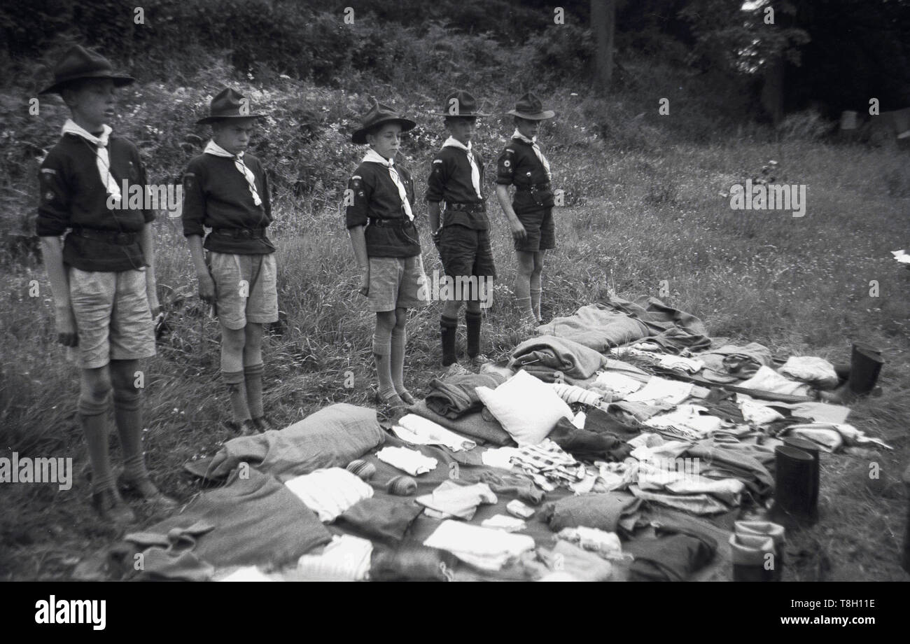 1940s, historical, young boy scouts stand in a line in a grassy field
