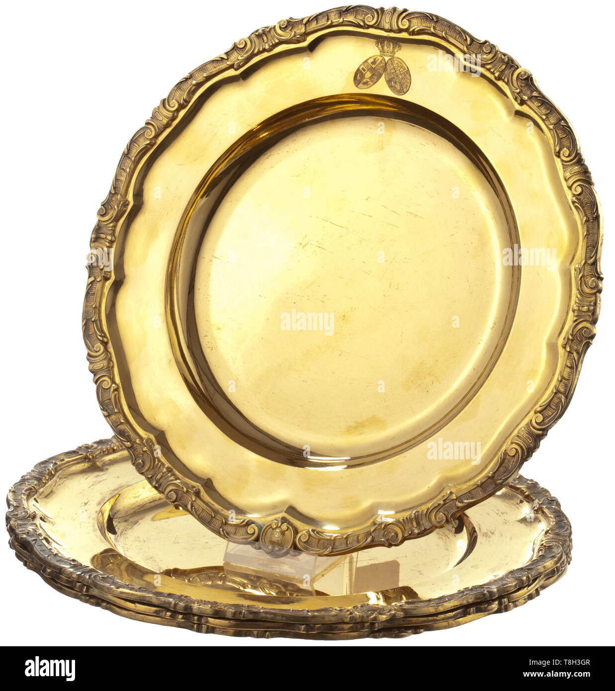 Four vermeil presentation plates on the occasion of the marriage of Grand Duke Frederick Francis IV and Princess Alexandra Luise of Hanover on 7 June 1904 Johannes Joost, Schwerin and Friedrich Gottschalk, Rostock, goldsmith respectively jeweller to the royal court. Silver, gilt scalloped rim with raised volute décor, the alliance coat of arms is engraved on each border. Hallmark '800' with crescent and crown stamped into each base, one plates bearing the dedication engraving (tr.) 'Gift of honour from the women of the City of Schwerin June 1904', Additional-Rights-Clearance-Info-Not-Available Stock Photo